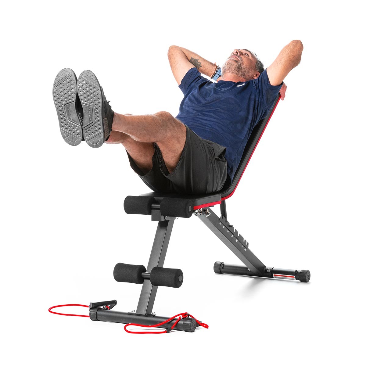 man exercises abdomen on trolly bench